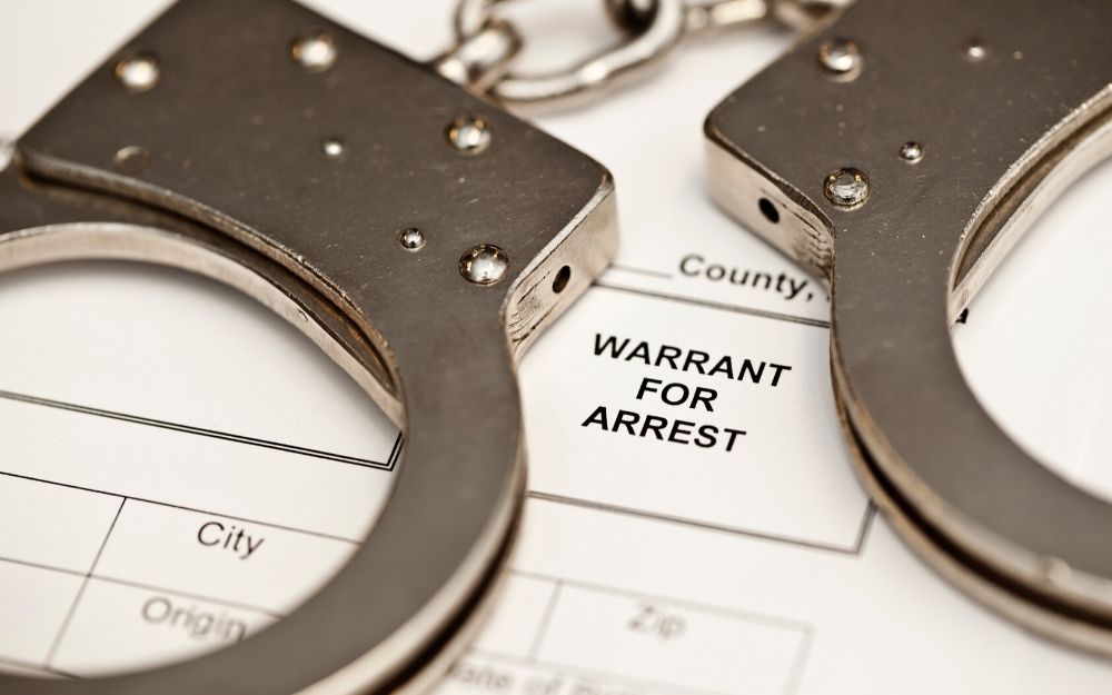 handcuffs on warrant of arrest