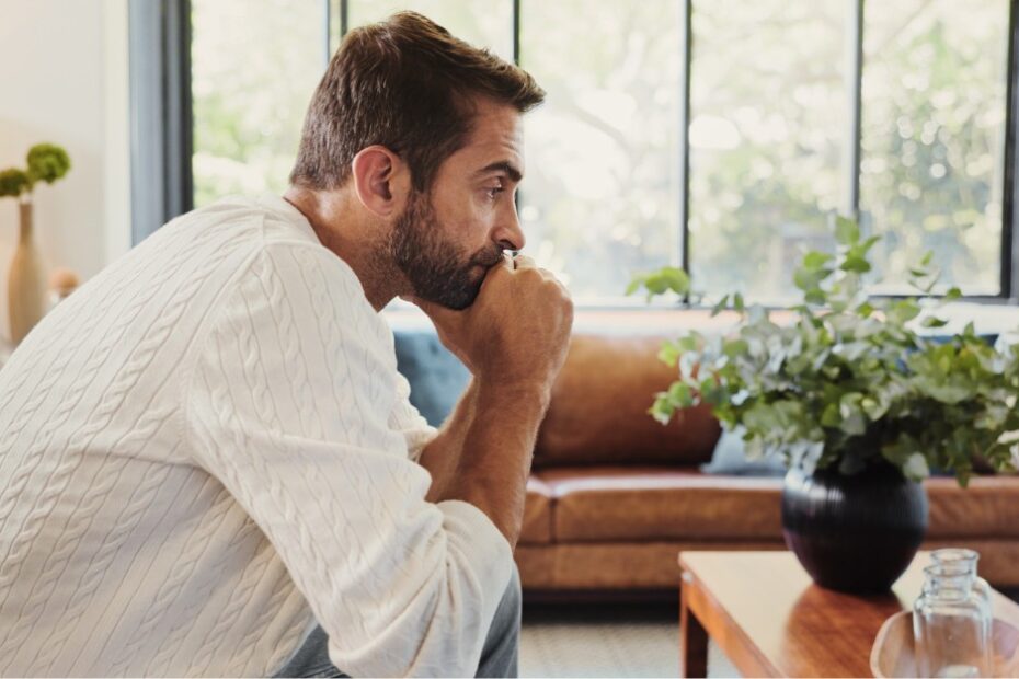 Pensive man sitting at home, thinking about sexual offence allegations